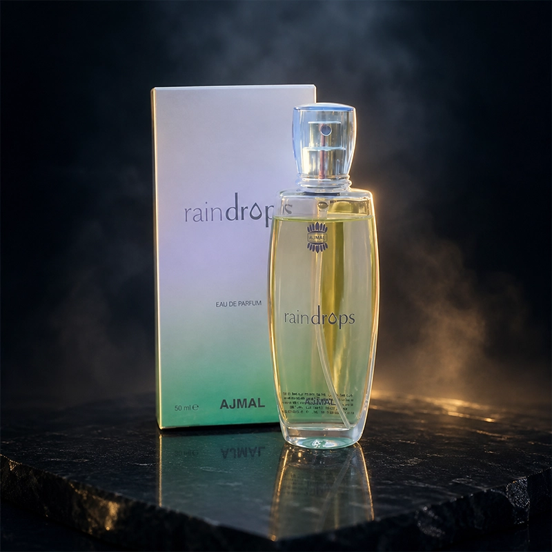 عطر اجمل رین‌دراپس زنانه 50 میلی‌لیتر با جعبه اصلی روی پس‌زمینه تیره و نورپردازی لوکس